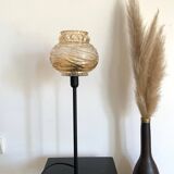 Table lamp with a textured antique globe and a golden base