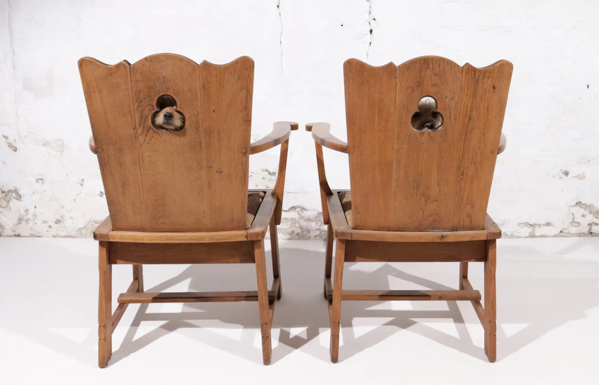 Pair of brutalist oak throne chairs with rush seats – Netherlands, 1930s