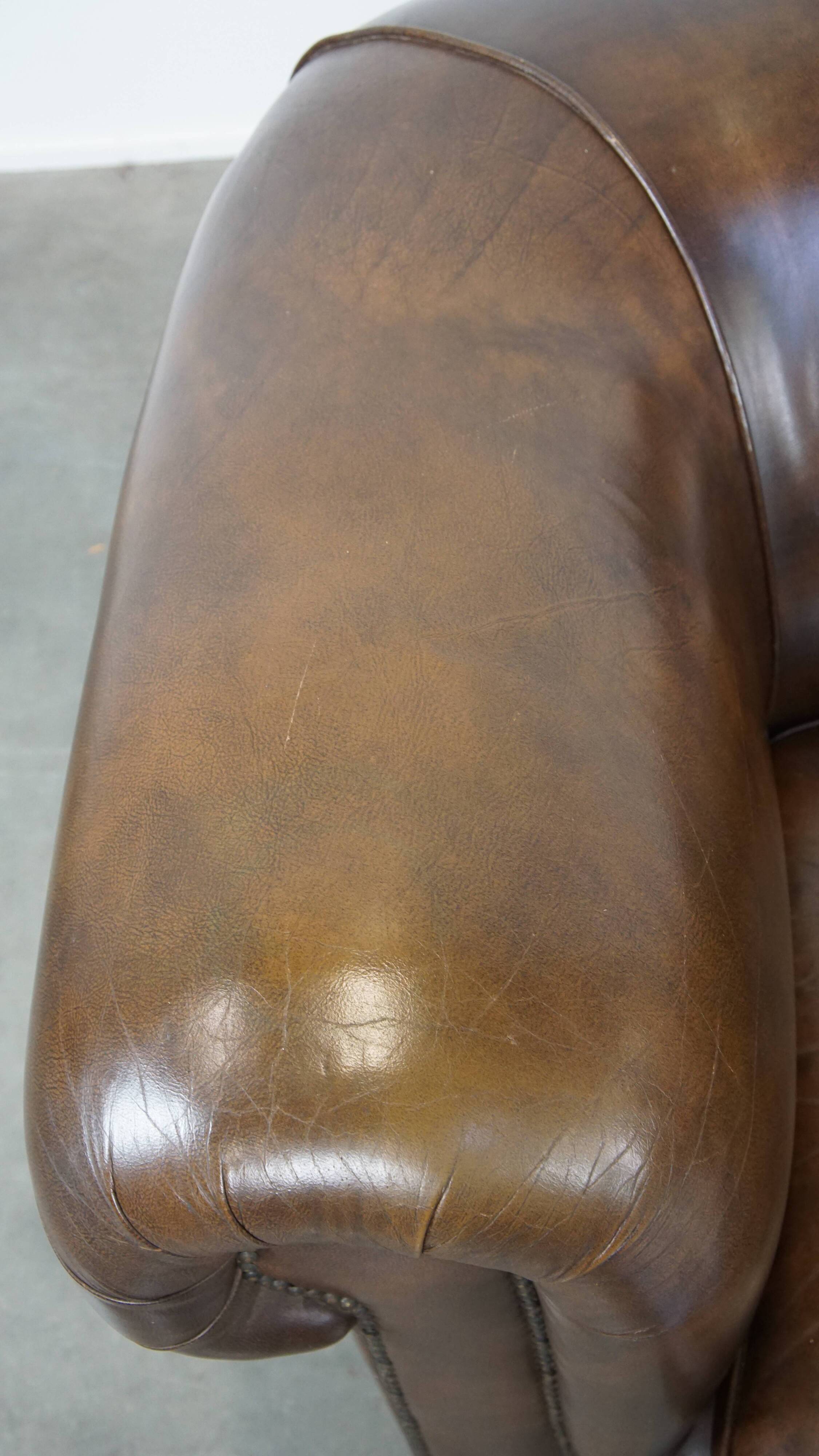2 Chesterfield armchairs in dark brown cowhide