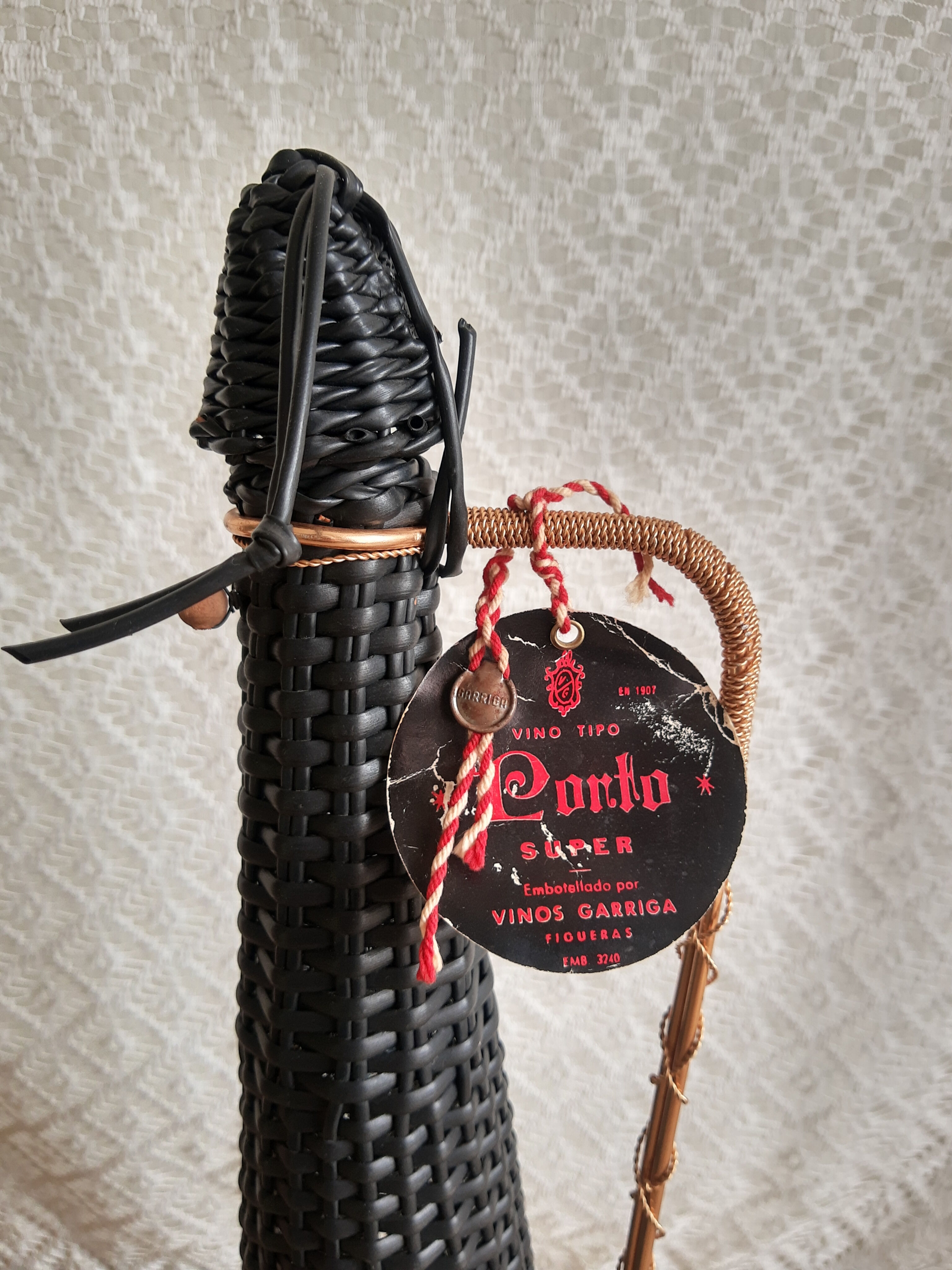 Glass bottle covered with black scoubidou with twisted golden handle - vintage