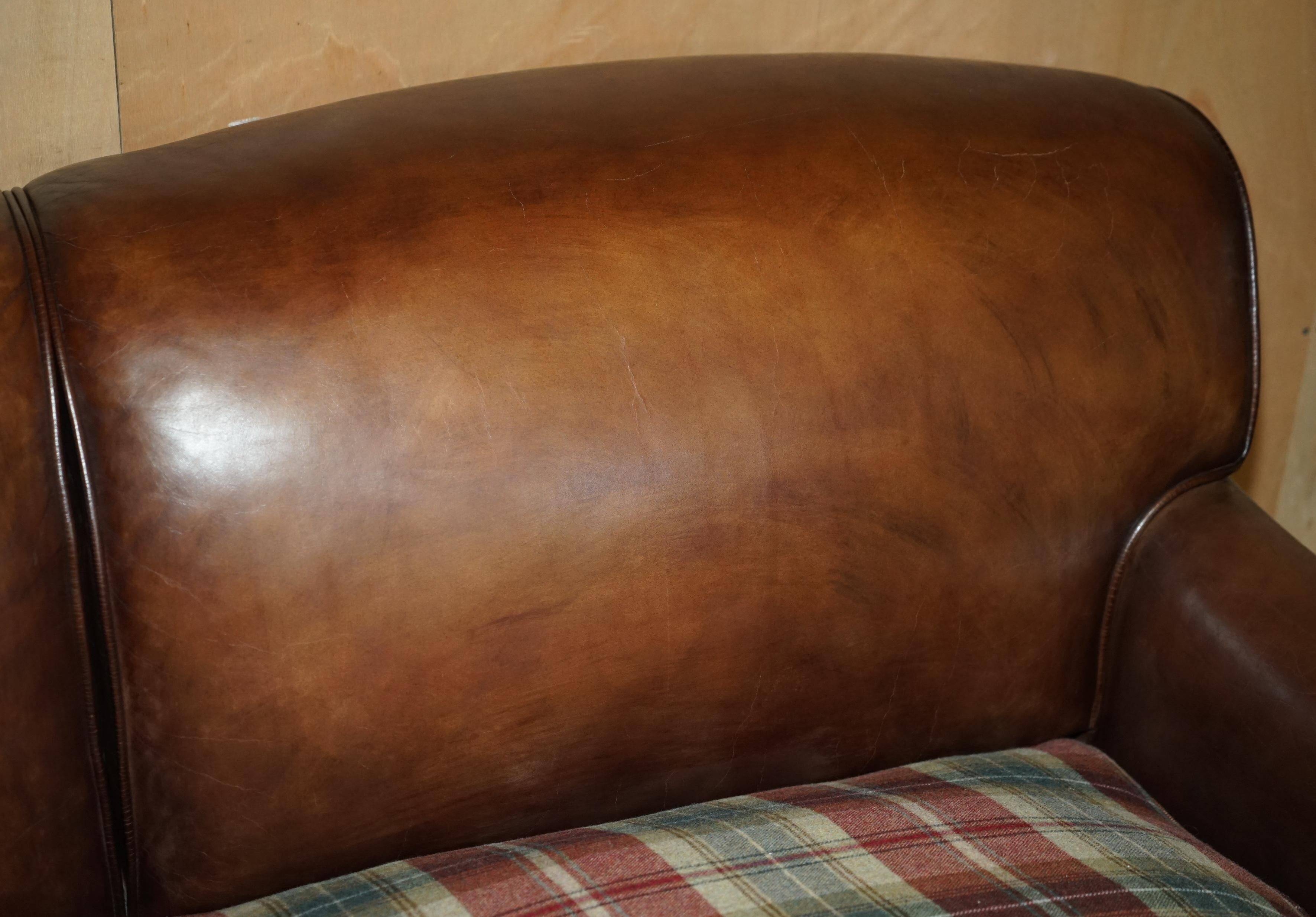 George Smith Signature Scroll leather canapé with tartan Scottish wool cushions.