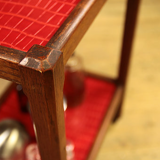 Serving in varnished chestnut and red leather