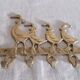 Wall-mounted tea towel holder or key holder in brass with ducks.