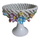 Cup on woven ceramic base with slip flowers