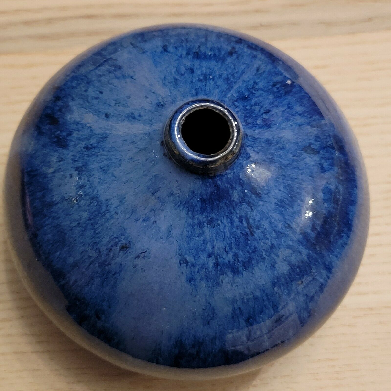 Small blue enamelled ceramic ball vase