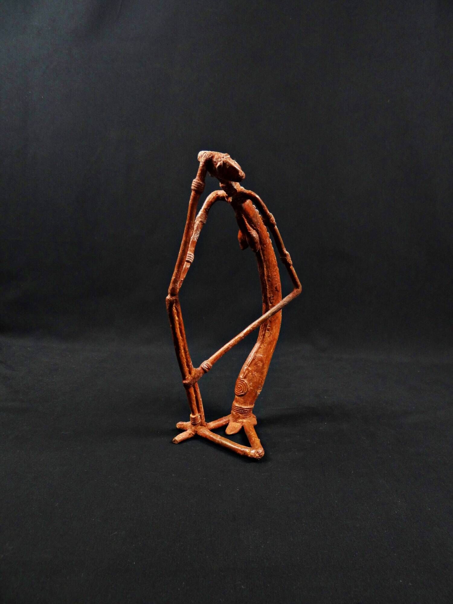 Dogon Nommo bronze statue with brown patina and red highlights, mid-20th century
