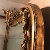 Large antique mirror with flagship shell in wood and gilded stucco