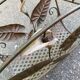 Vintage wrought iron magazine rack with flower pattern.