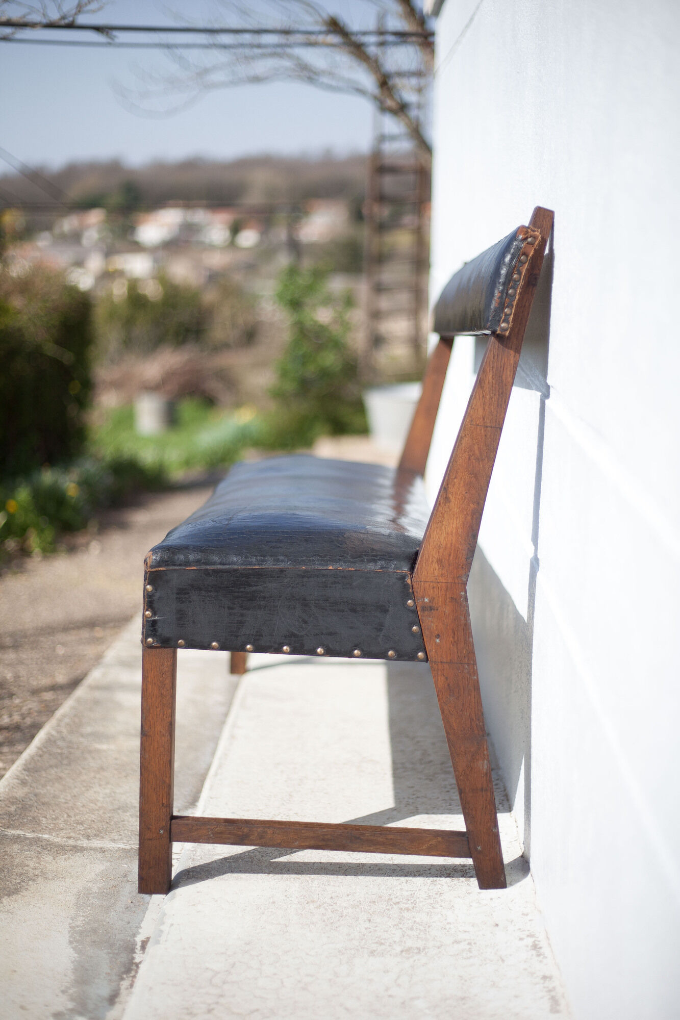 Antique wood bench and black imitation leather
