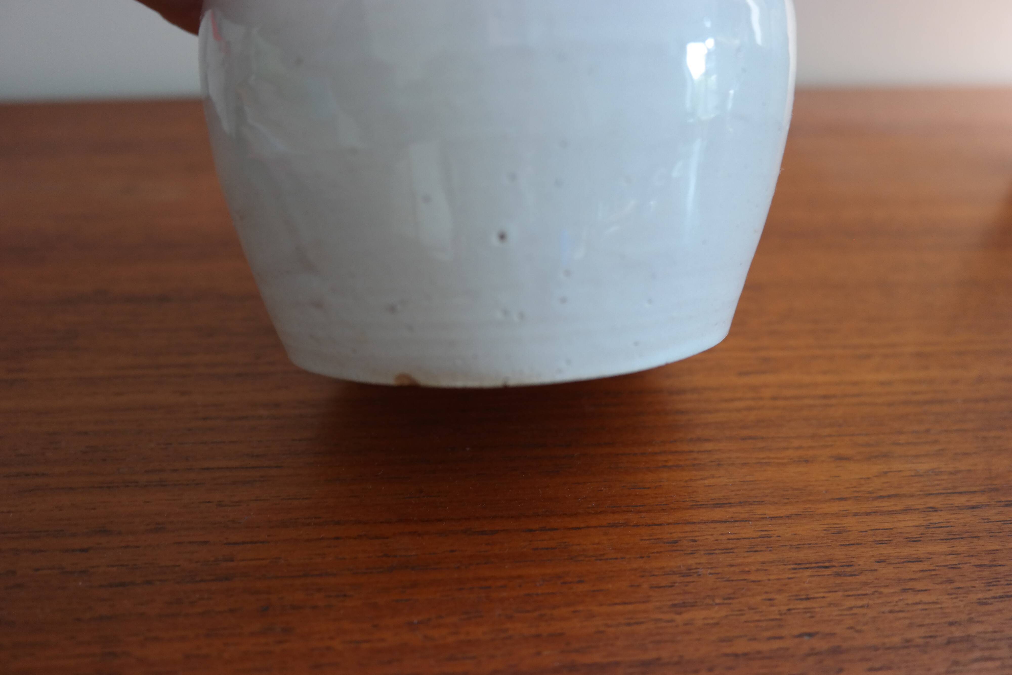 White enamelled earthenware flower vase signed HR