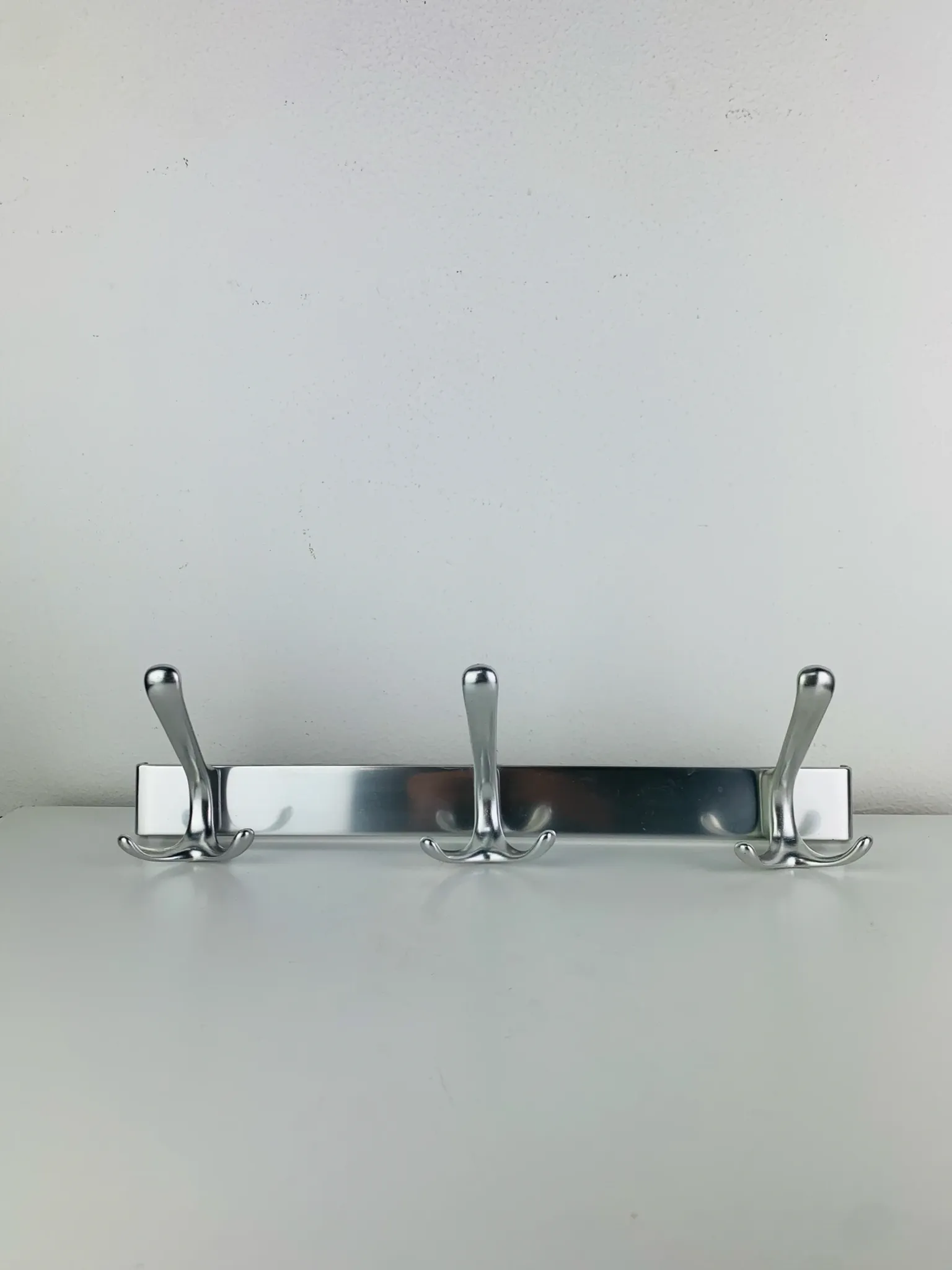 Wall-mounted coat rack, strip of 3 aluminium hooks from the 1960s.