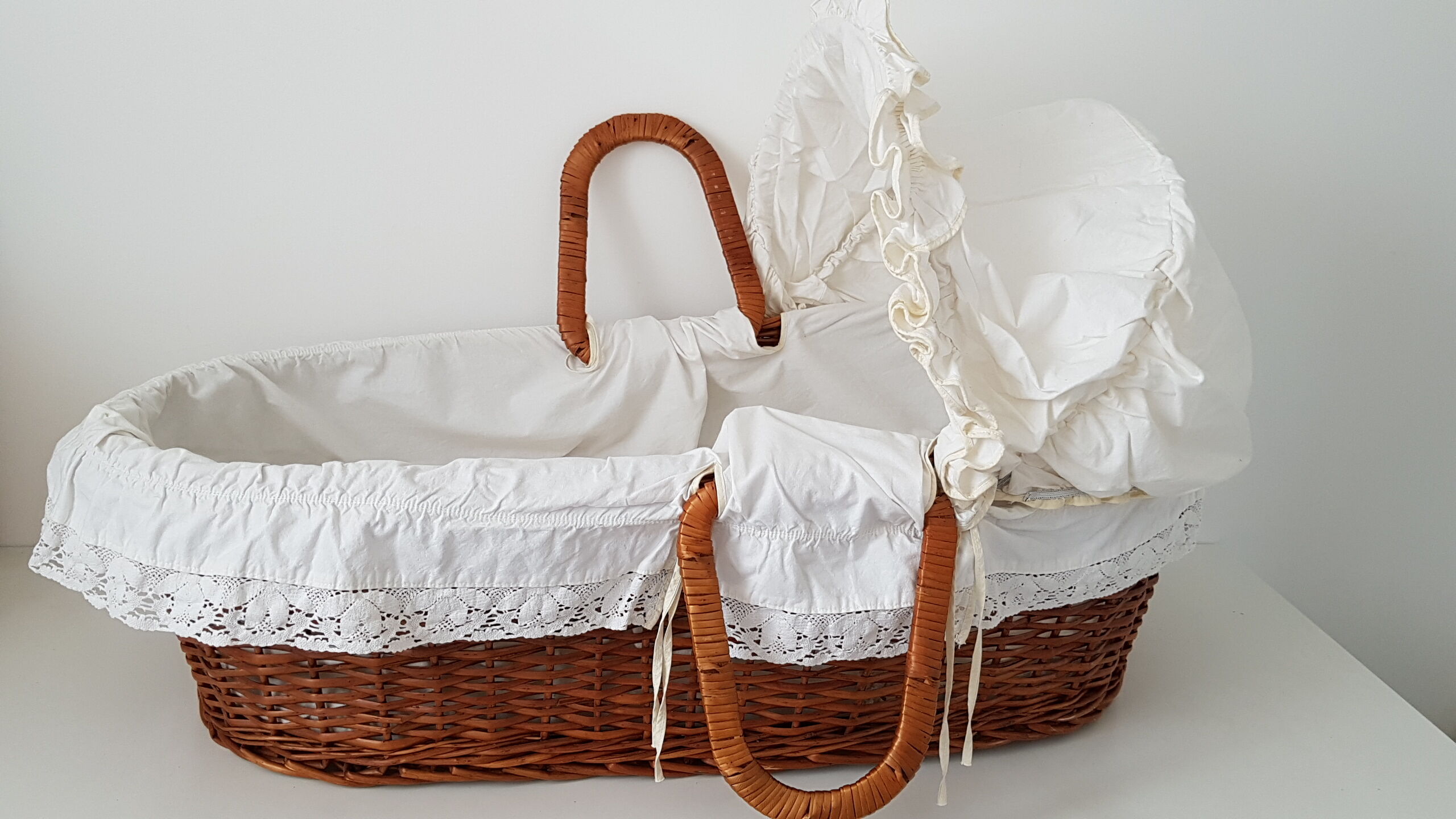 Old rattan bassinet and bedding