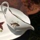 Large fish platter and its vintage porcelain sauce boat, decorated with pike.