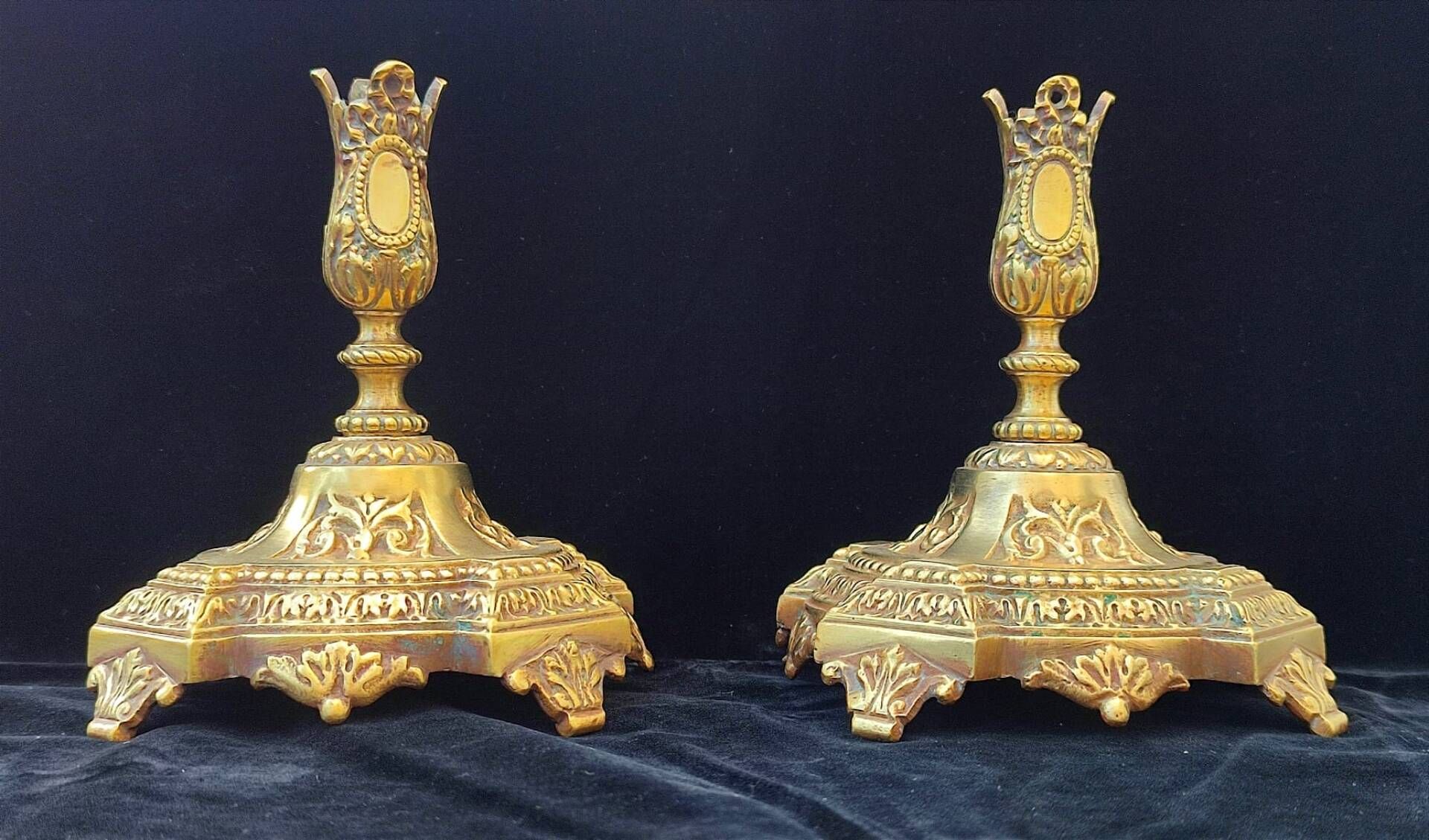 Pair of antique carved bronze candlesticks.
