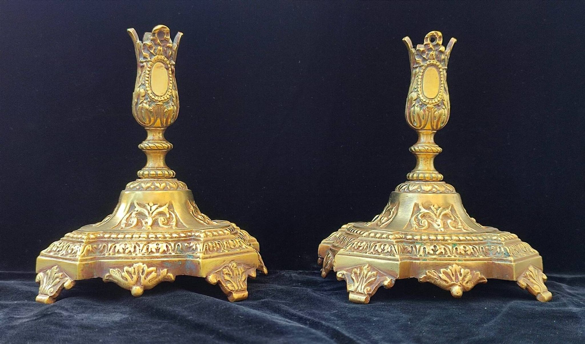 Pair of antique carved bronze candlesticks.