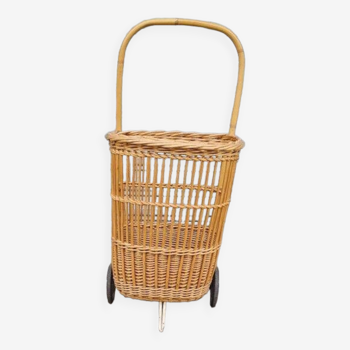 Vintage wicker log basket on vintage wheels