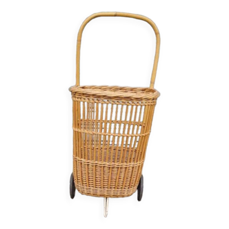 Vintage wicker log basket on vintage wheels