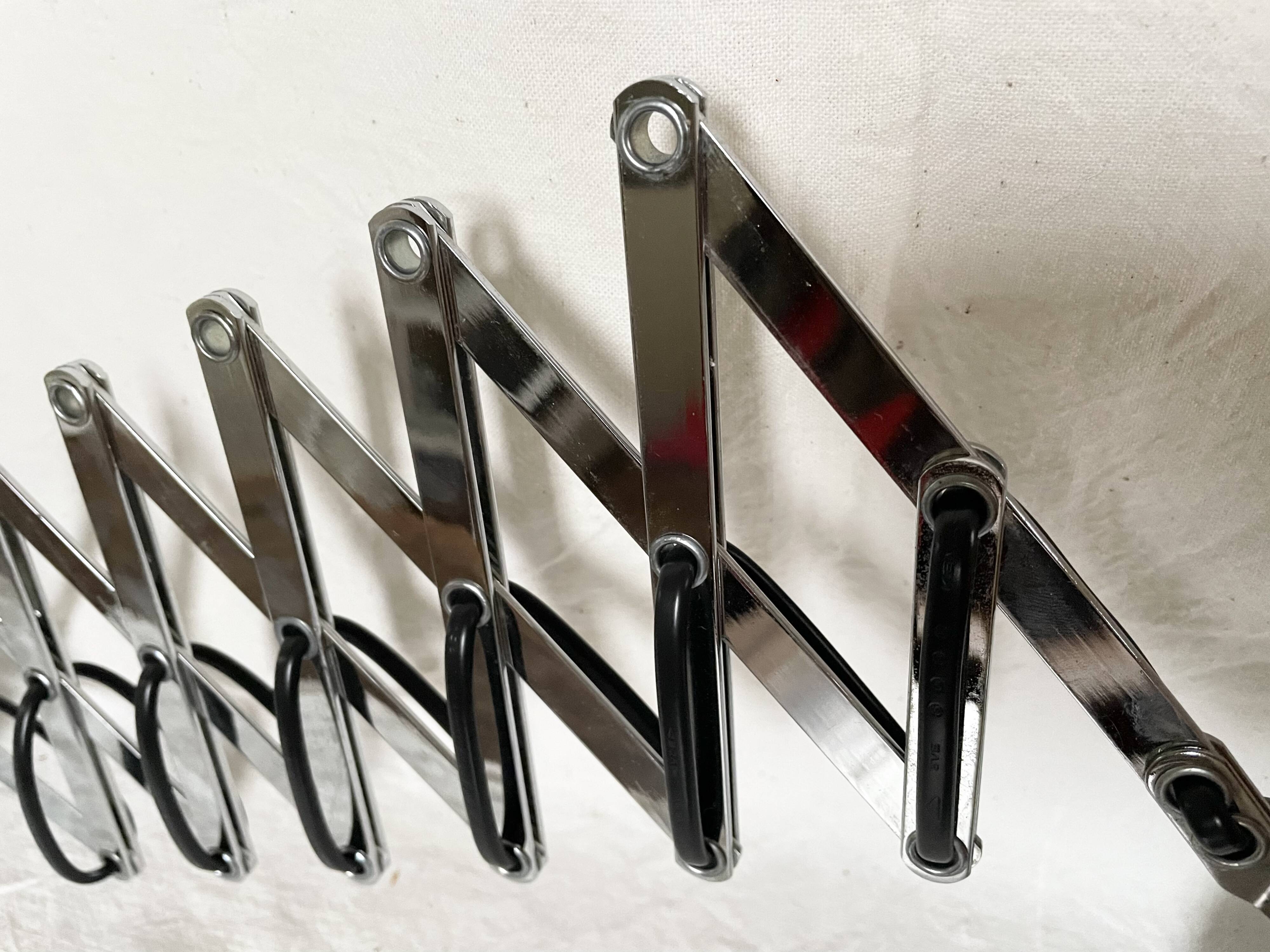Vintage accordion wall light in chrome metal.