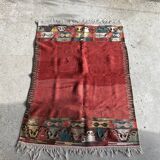 Small wool rug, predominantly red with geometric patterns