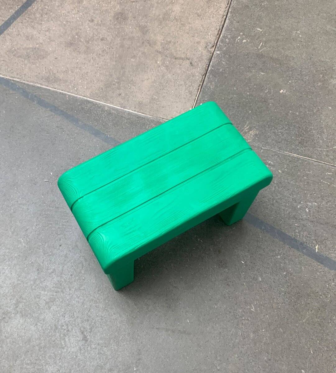 Postmodern plastic stool with a wood effect.