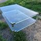 Coffee table in plexiglass and brass.