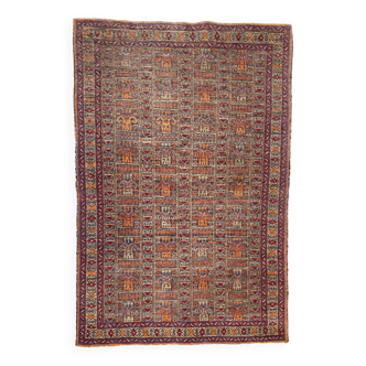 Vintage hand-knotted rug decorated with geometric patterns on an orange background 135 x 80 cm