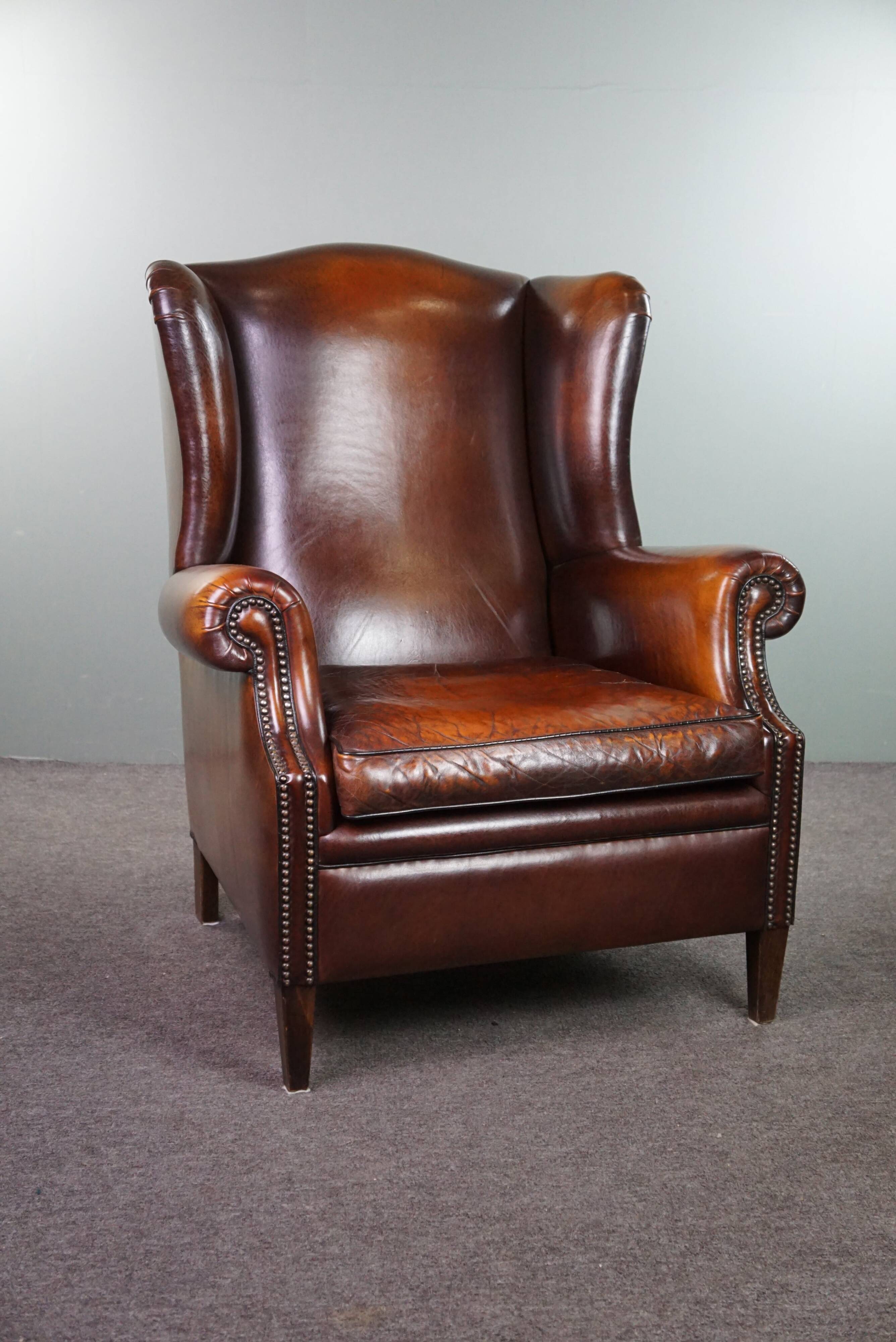 Luxurious large sheep leather wingback armchair with beautiful colors and amazing patina