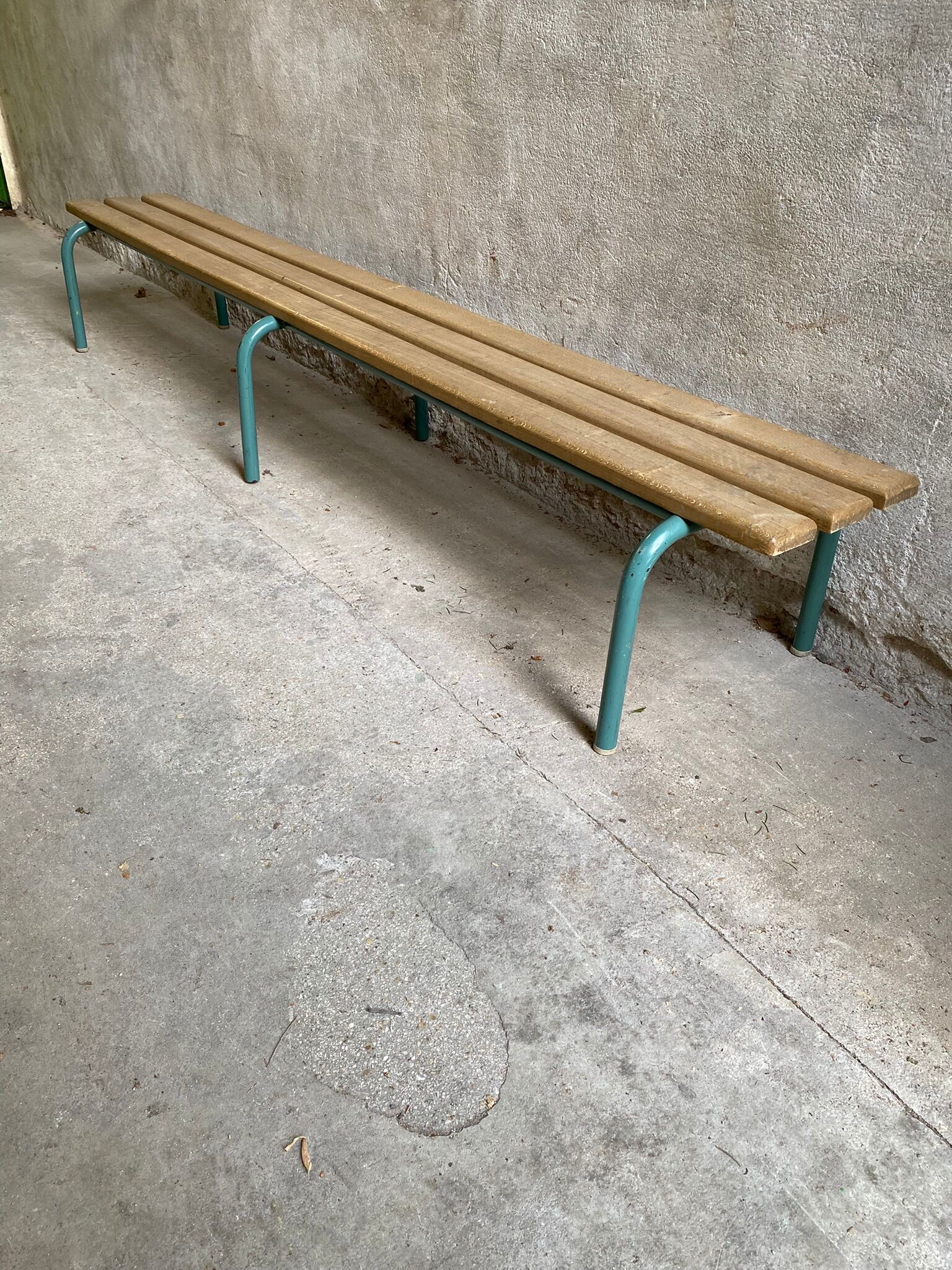 Vintage wood kindergarten bench and tubular structure in long