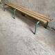 Vintage wood kindergarten bench and tubular structure in long