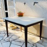Vintage oak farmhouse table with a white top.