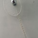 Apply tennis racket in 1980s Plexiglas
