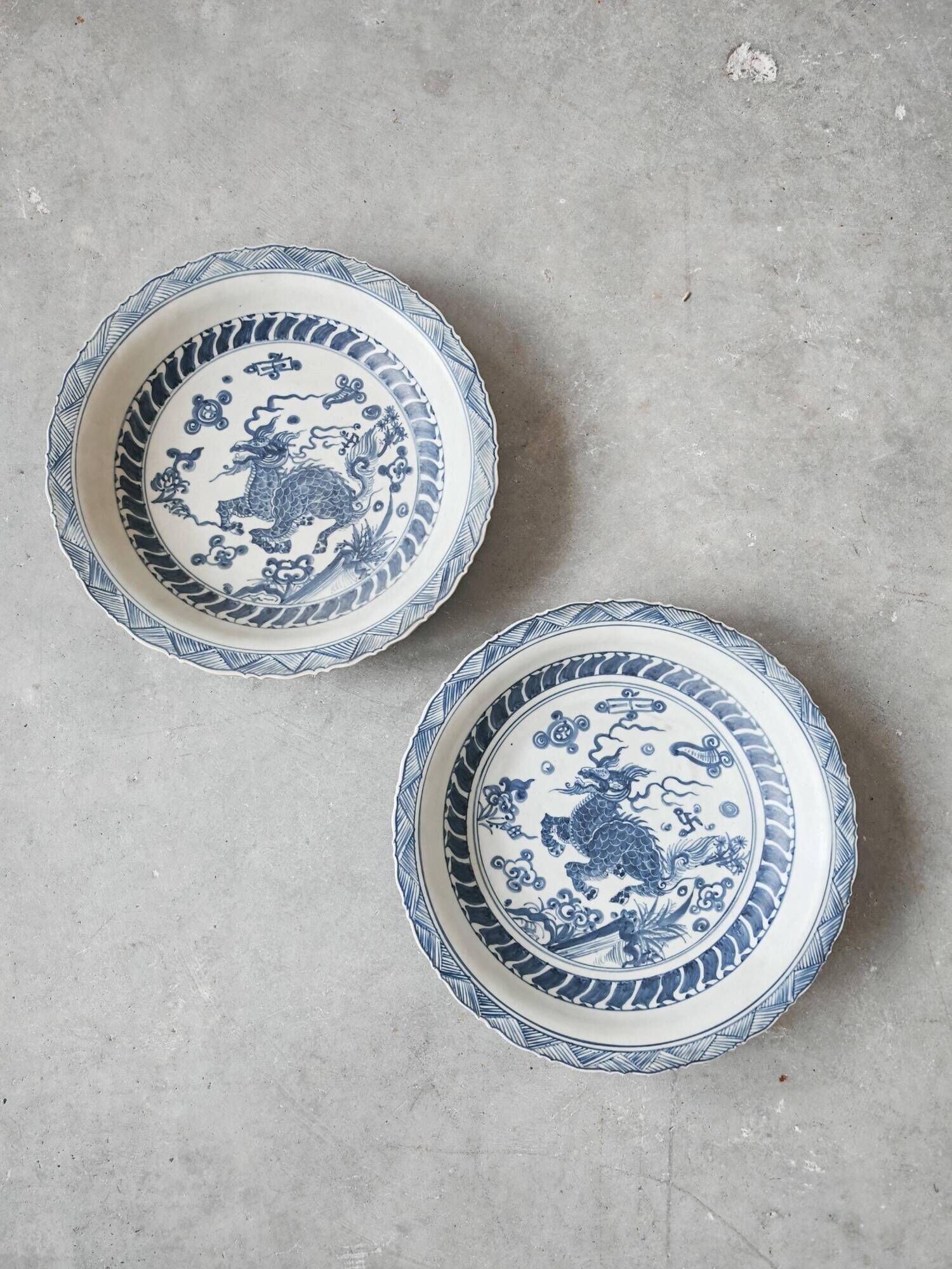 Pair of antique Chinese decorative plates with dragon motif.