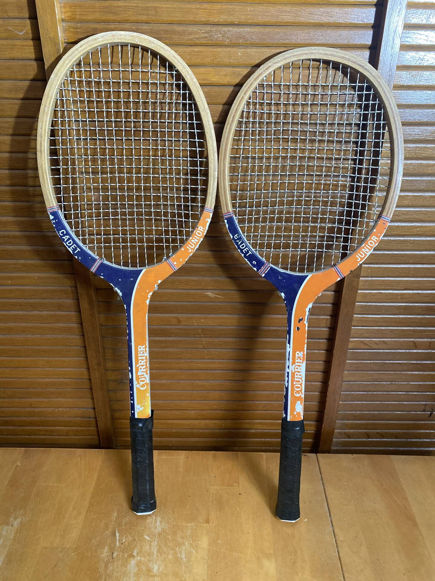Pair of vintage wooden tennis rackets for cadet junior sport courier