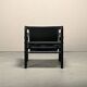 Fauteuil de salon Sirocco Safari Arne Norell en cuir noir et frêne teinté.