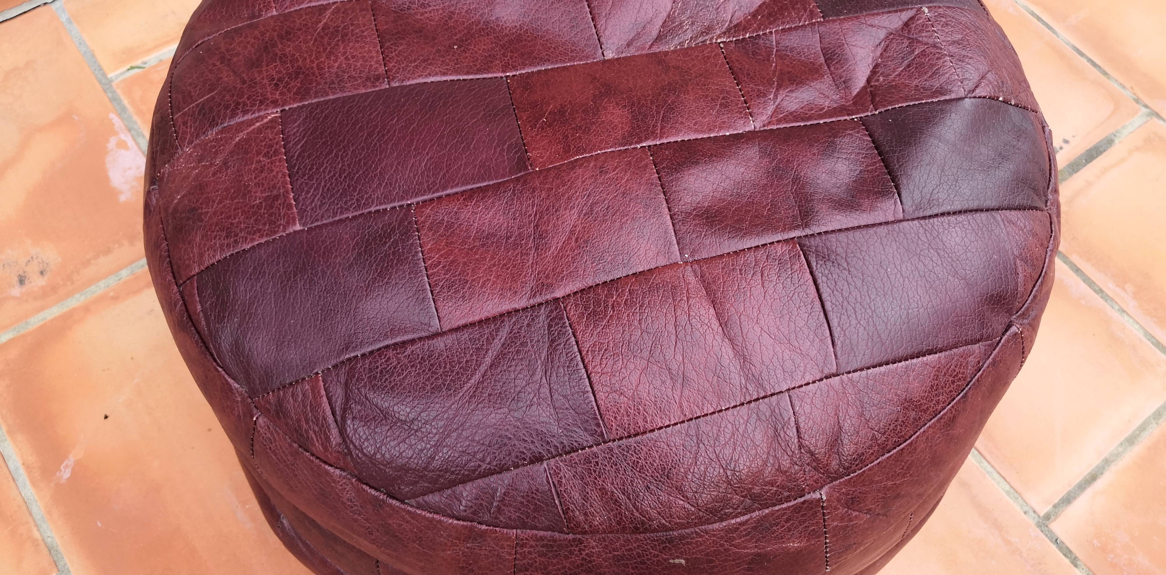 Pair of vintage poufs in burgundy leather patchwork, 1970