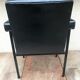 Ancien fauteuil structure métal noir et skaï noir