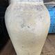 Yellow patinated cement grain jar