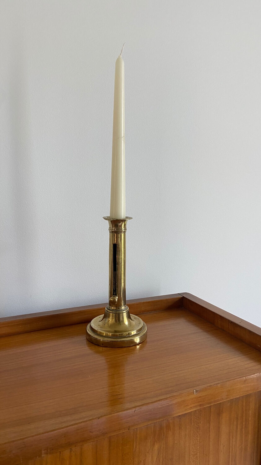 Old brass push candle holder