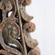 Indonesian construction element in carved wood with intertwined plant motifs mounted on a base (fri