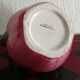 Pink pitcher in the shape of a strawberry, Italian slurry.