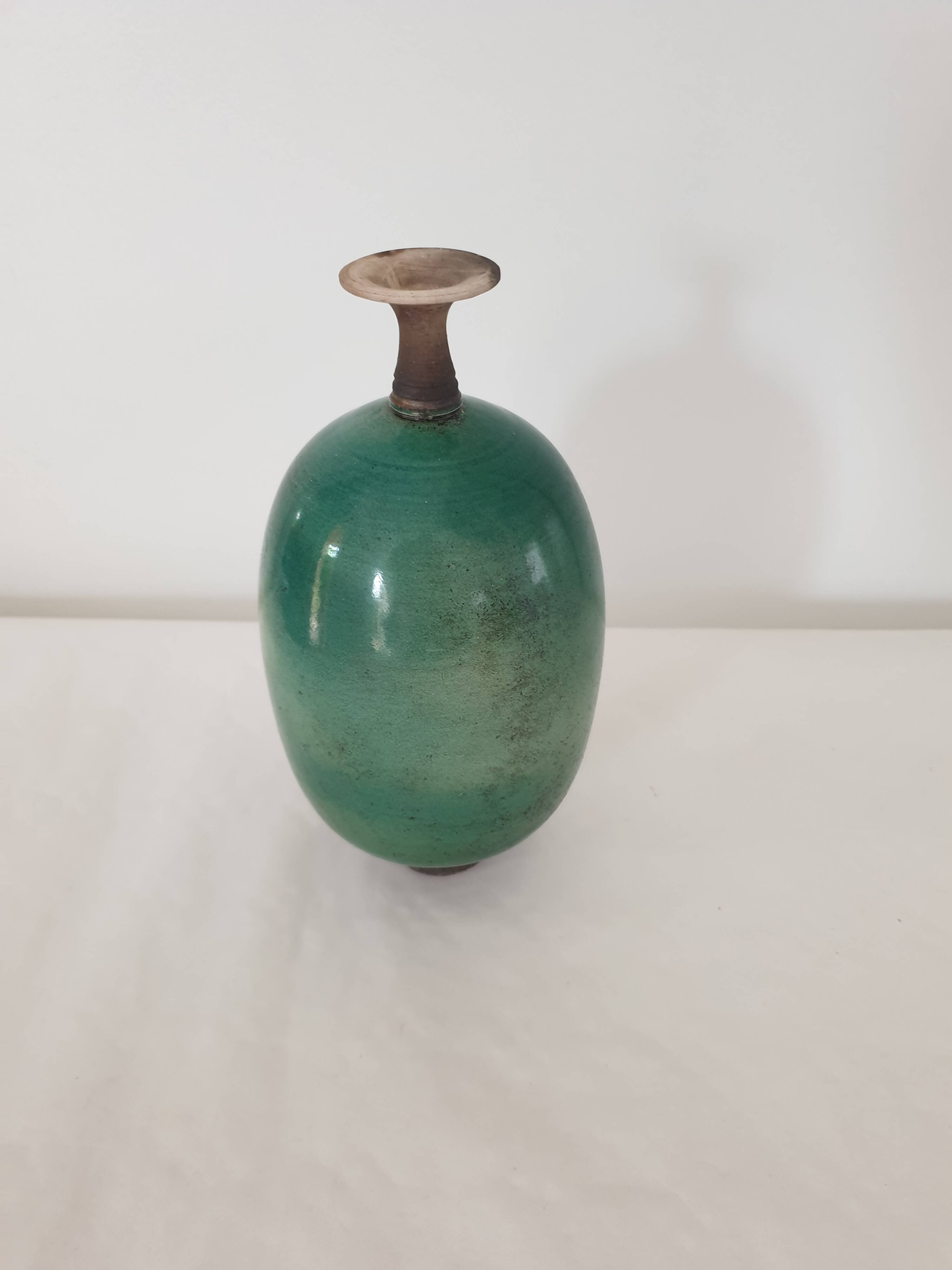 Green pot-bellied ceramic vase with foot and high, narrow neck in signed raku