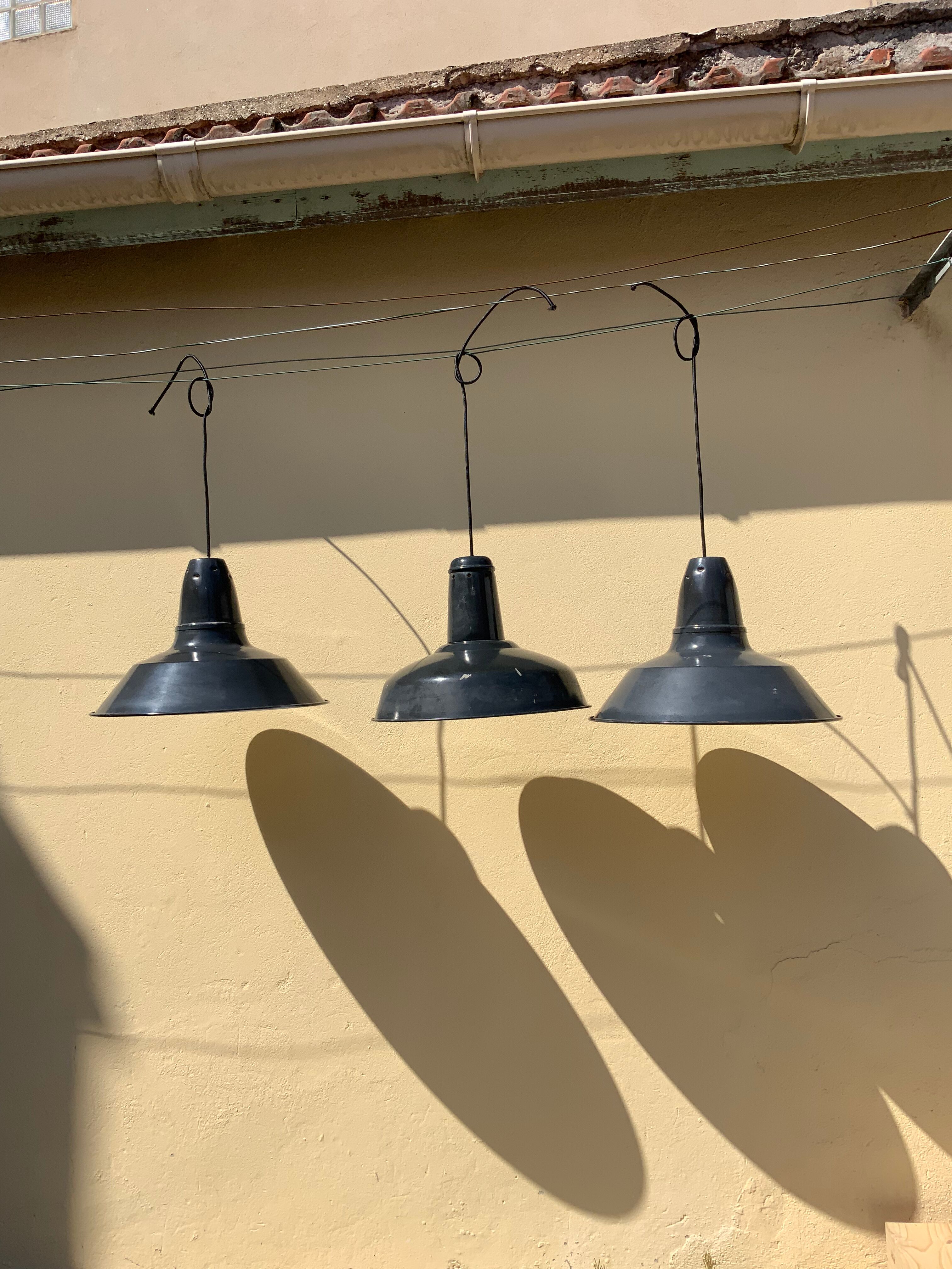 Three industrial suspensions in black and white enamelled sheet metal large format