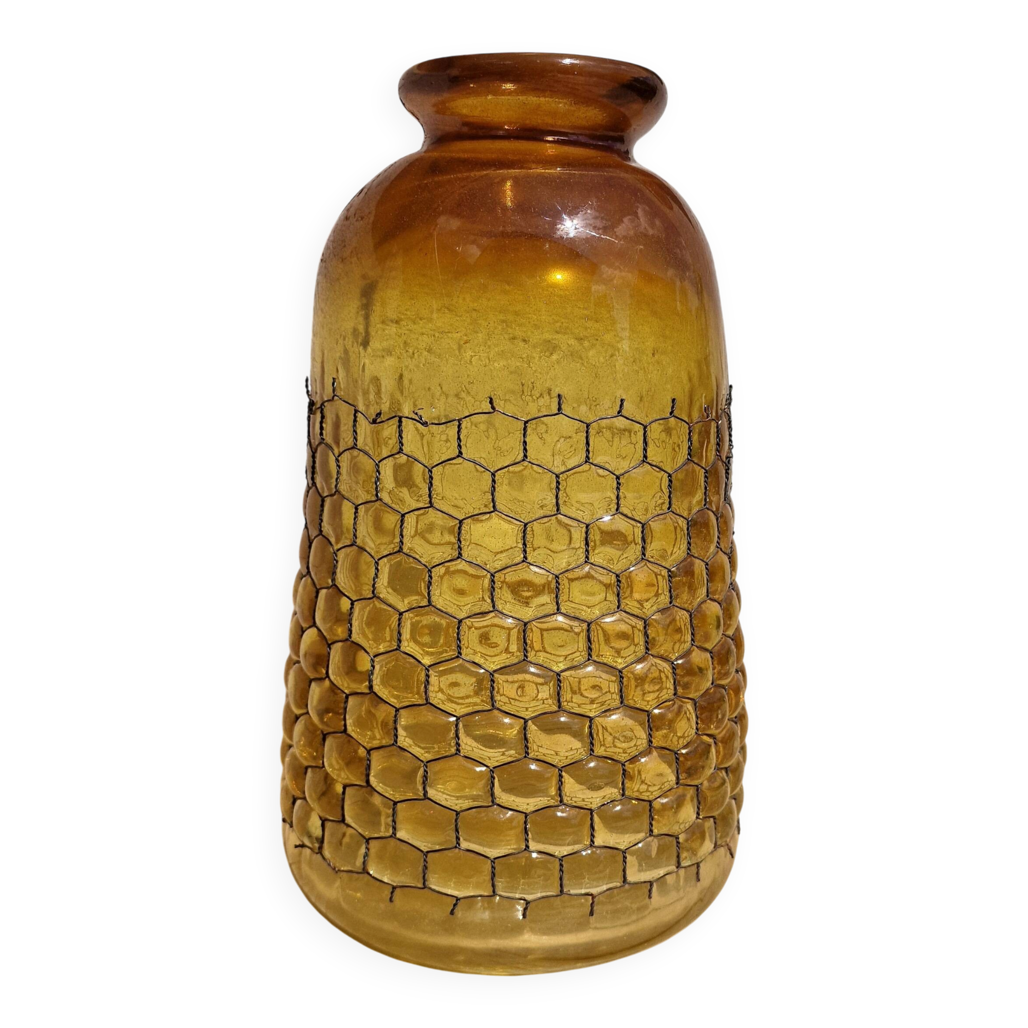 Artisanal blown amber glass vase with integrated honeycomb structure.