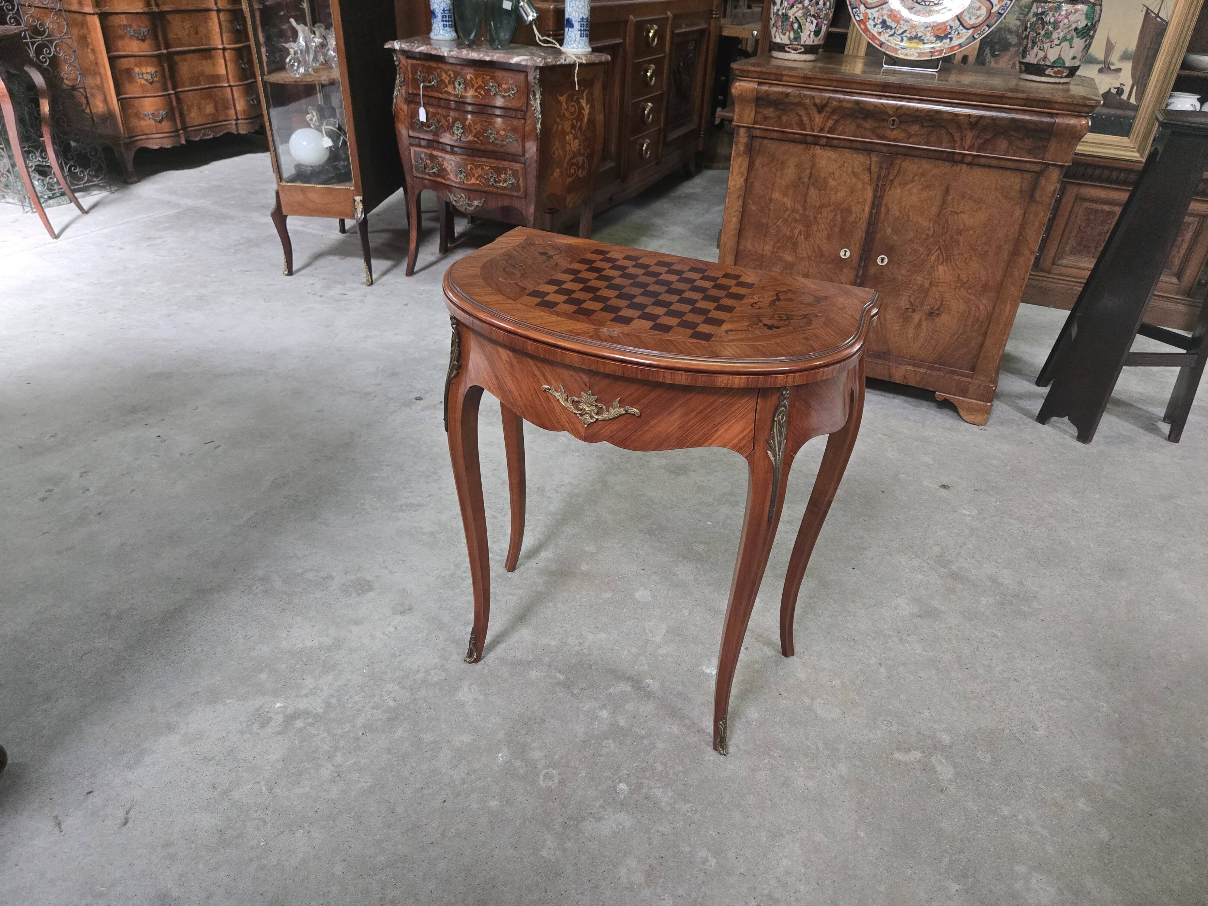 Half-moon gaming table in Louis XV style, made of precious wood marquetry.