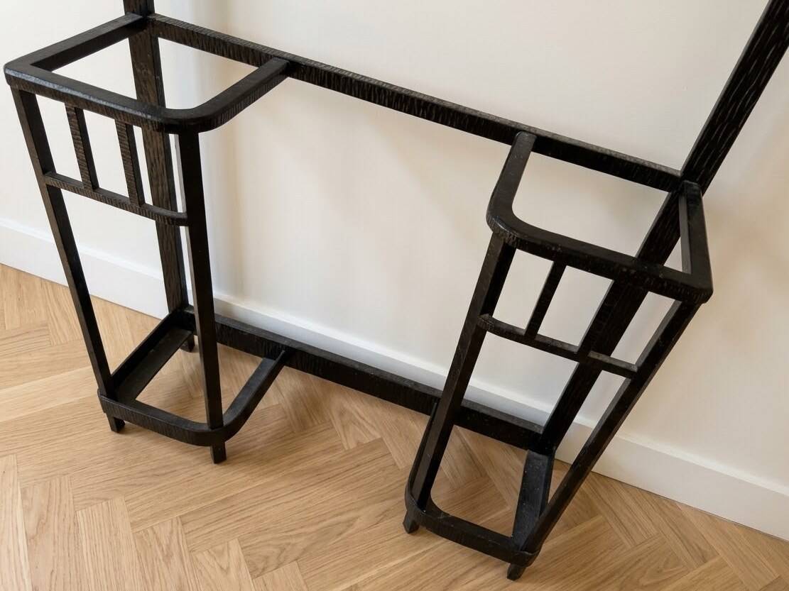 Antique black wrought iron coat rack with mirror.