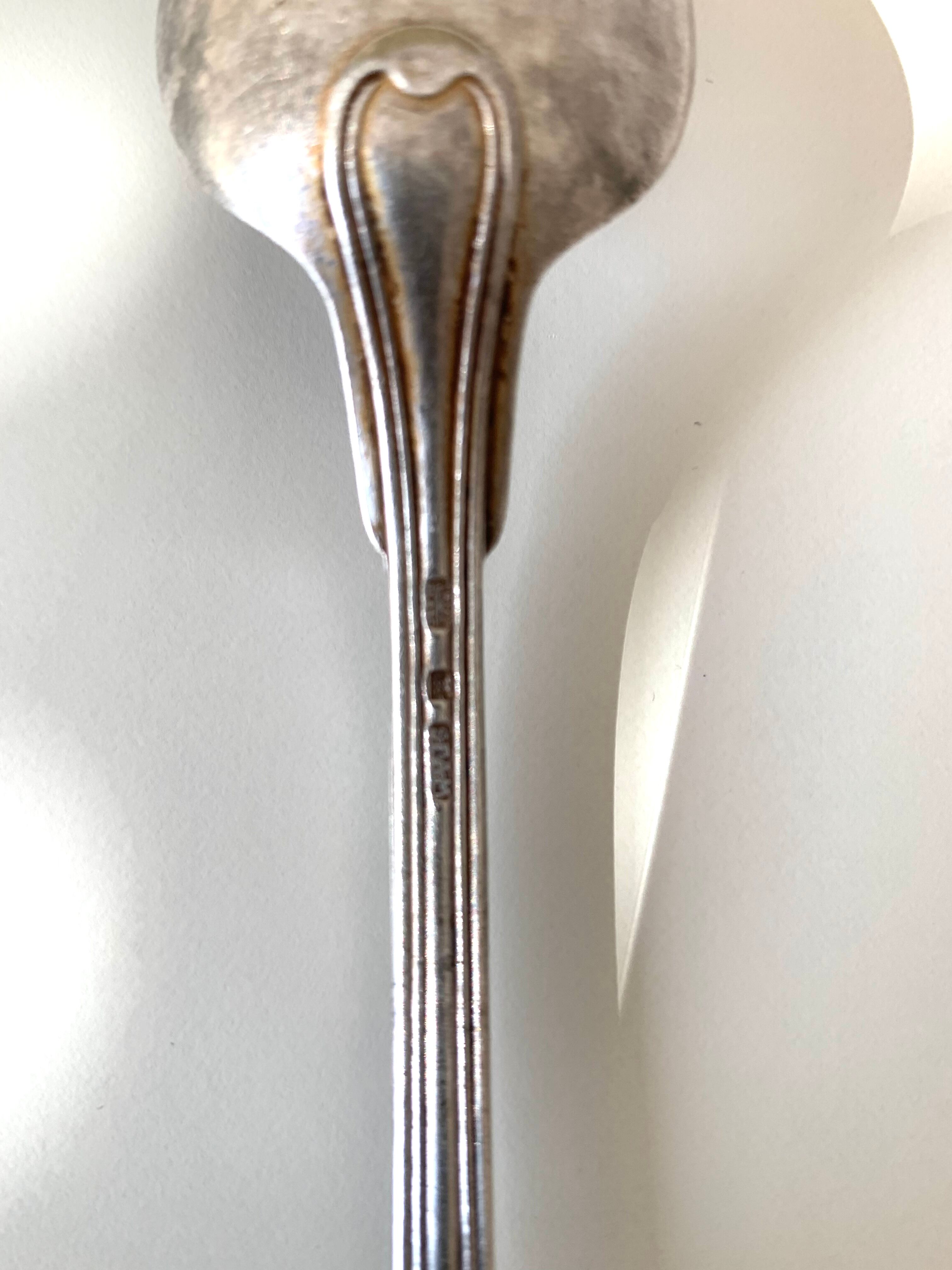 8 silver metal spoons