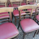Set of 8 bistro chairs in vintage red wood and leatherette.