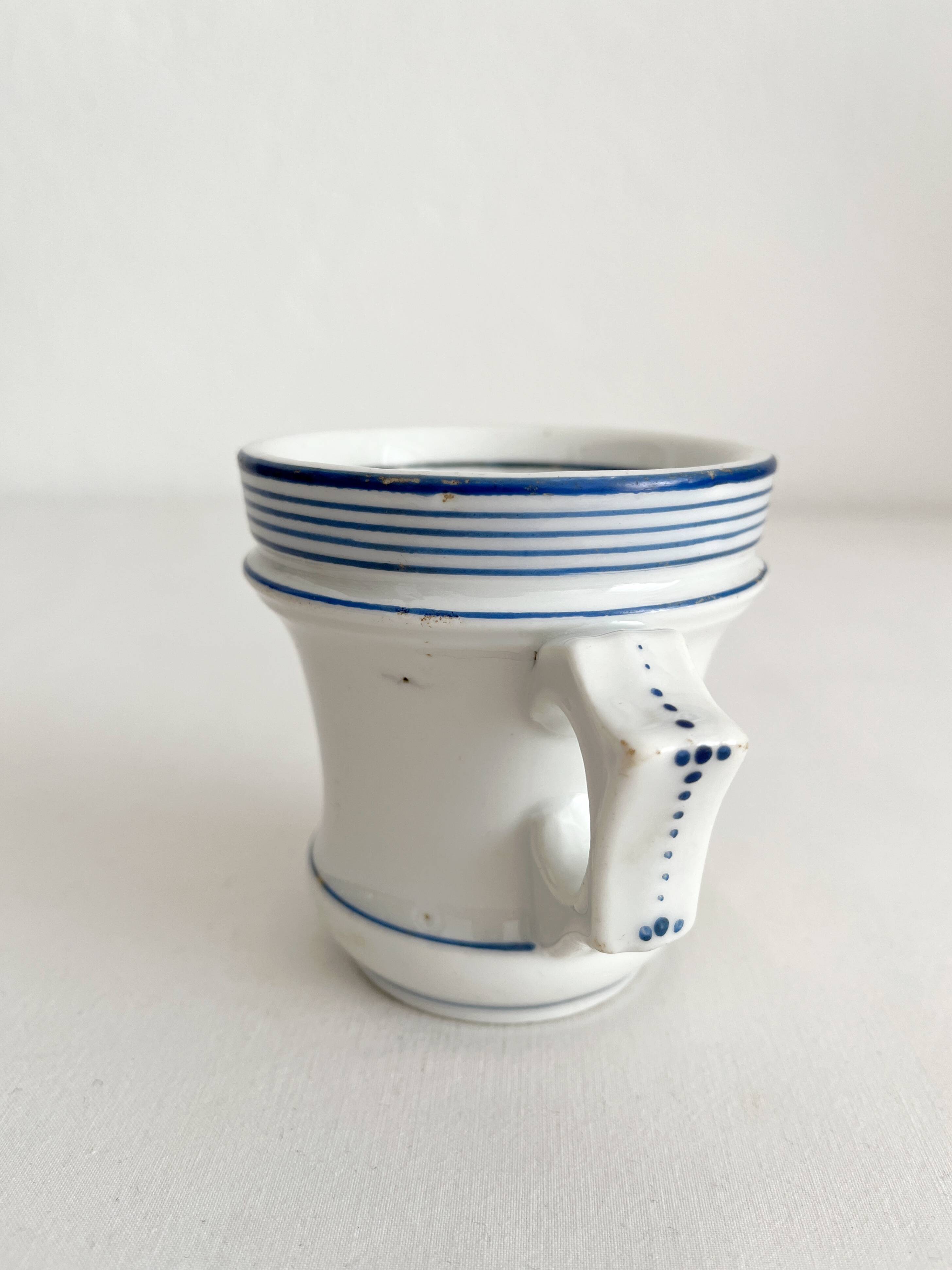 Antique porcelain teacup with blue rims, 19th century
