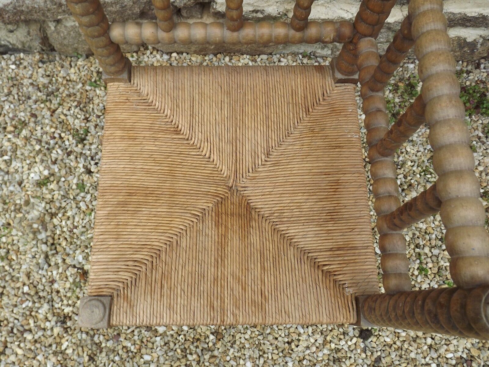 French antique turned wooden bobbin chair with rush seat