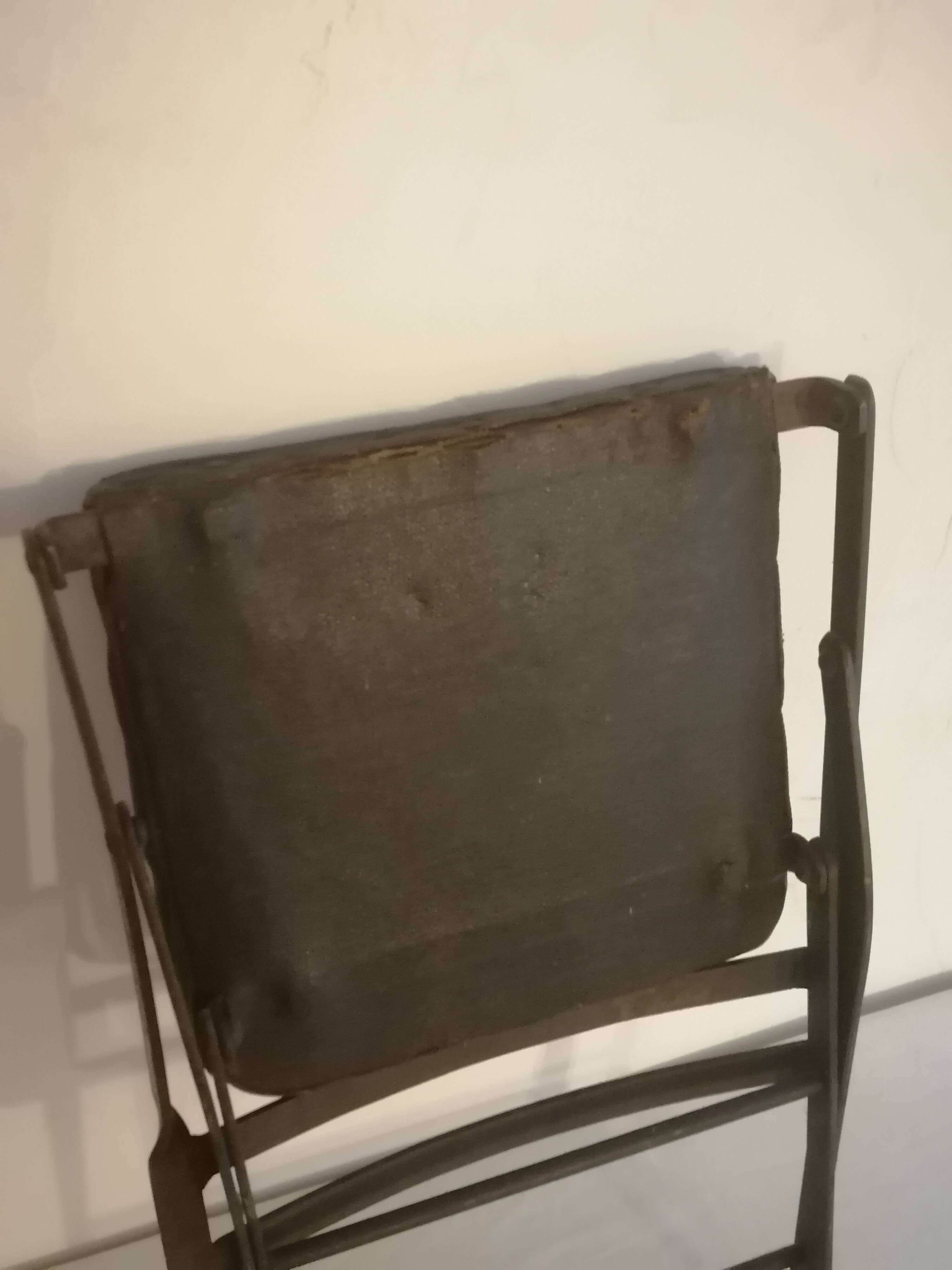 Old wrought iron folding children's chair. Early 20th century.